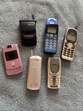 Vintage Collection of cell phones includes StarTAC and Pink Flip